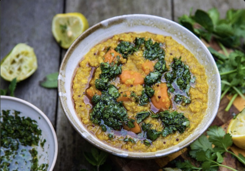 A bowl of kitchari with sweet potato, cilantro chutney and lemon